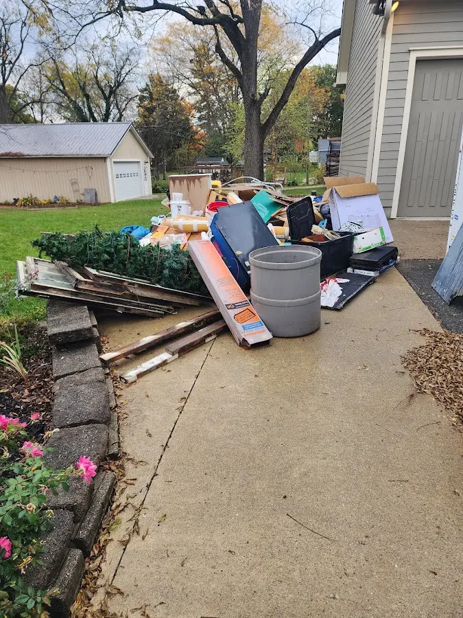 Dumpster being loaded with debris for 10 Yard Dumpster Rental in Bartlett